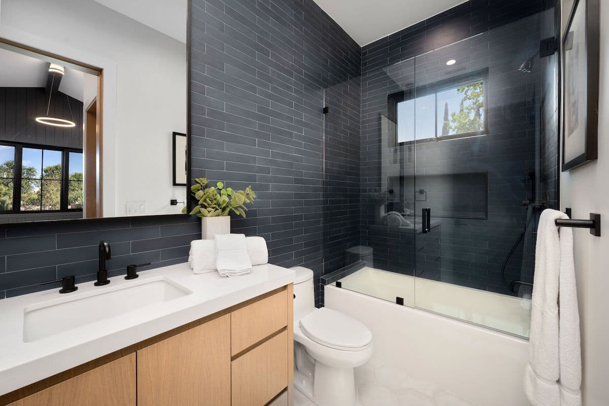 Bathroom with a charcoal and white color scheme.