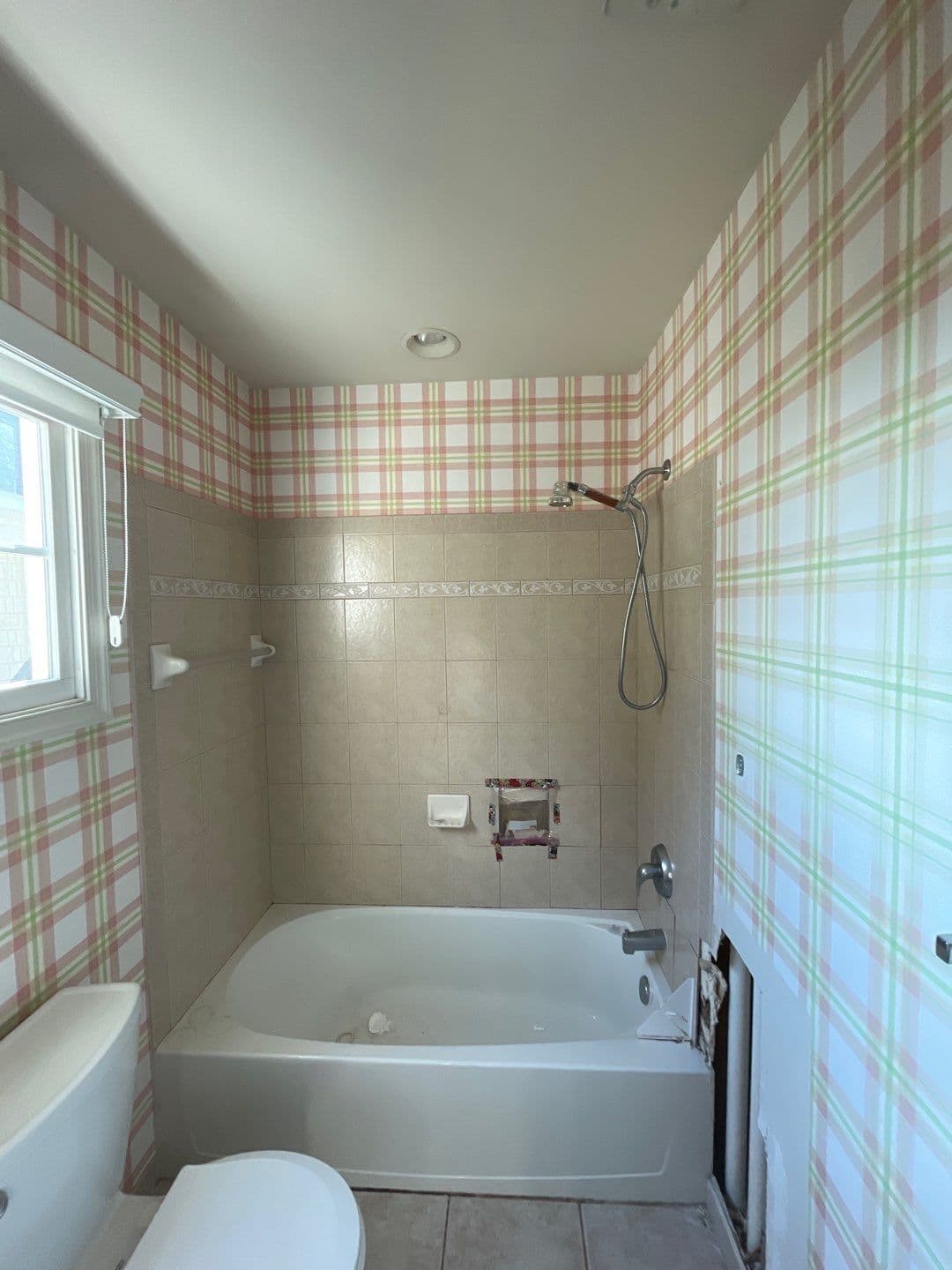 A before photo of a combination shower tub.