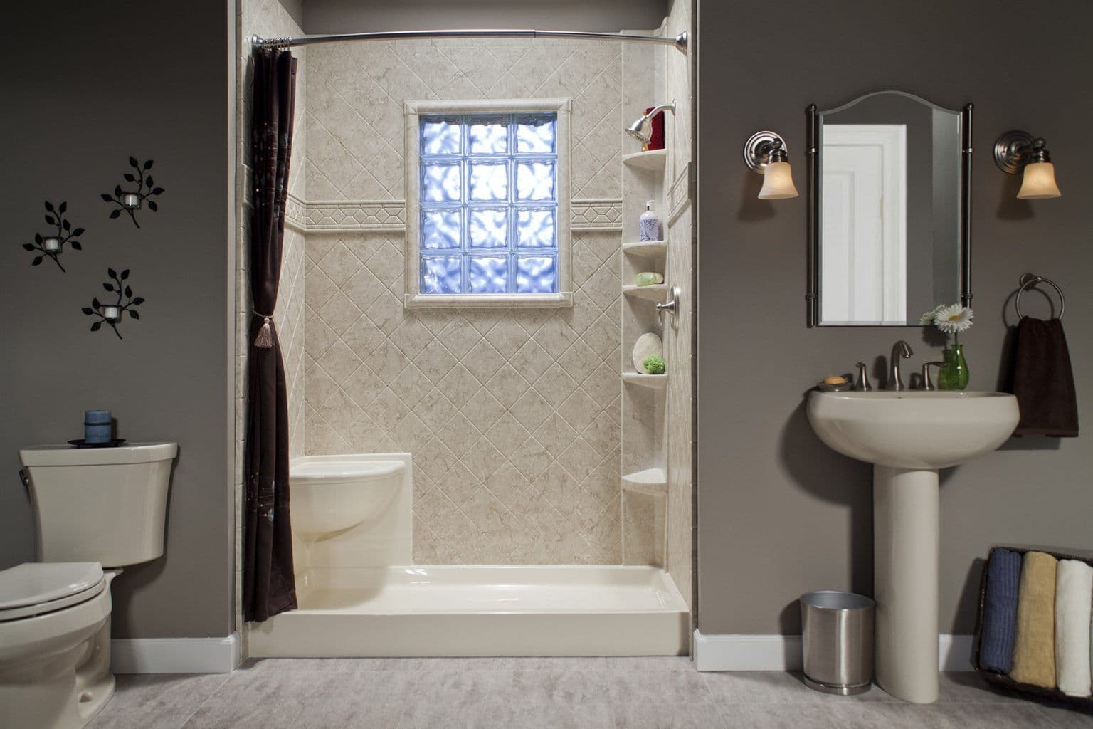 A walk-in shower with a window and built-in corner shelves and bench.