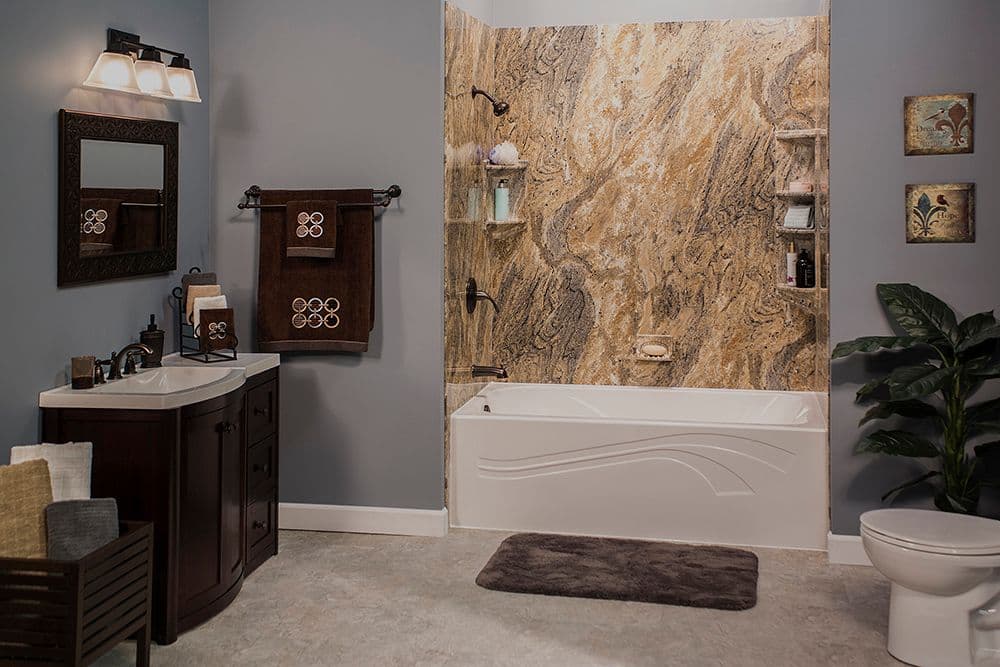 A gray bathroom with a combination shower tub with brown marbled walls.