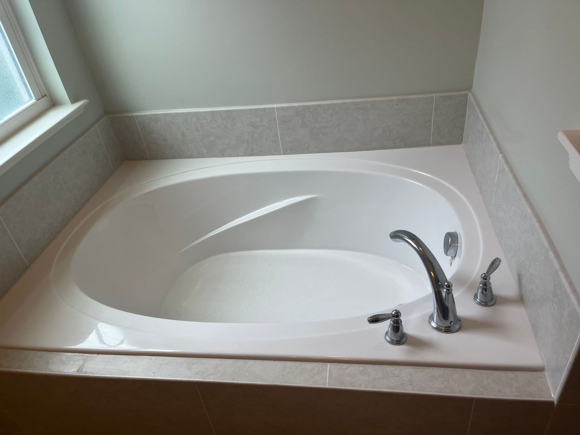A large replacement soaking bathtub.