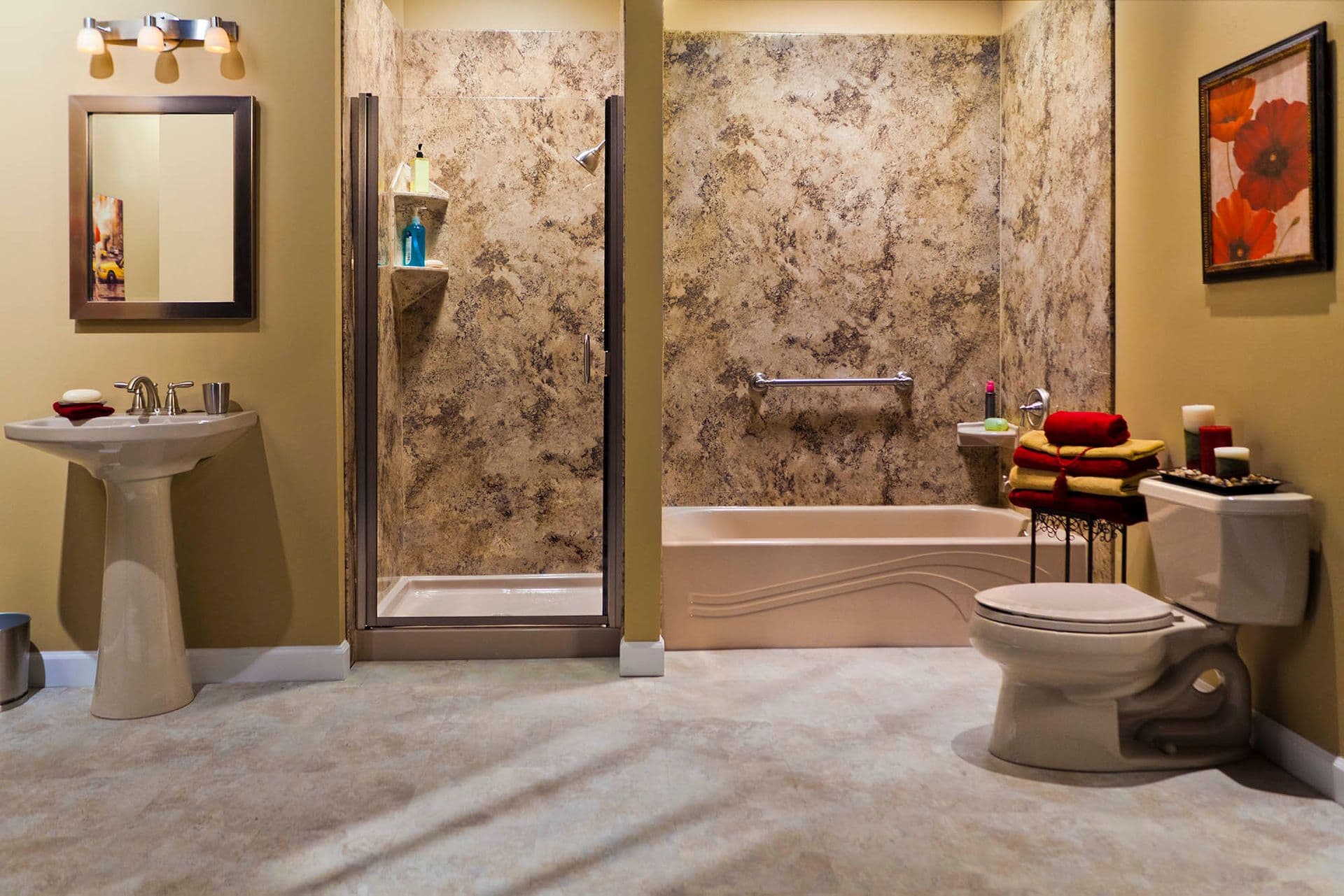 A tan bathroom with a separate shower stall and bathtub with brown marbled walls and a horizontal safety grab bar.