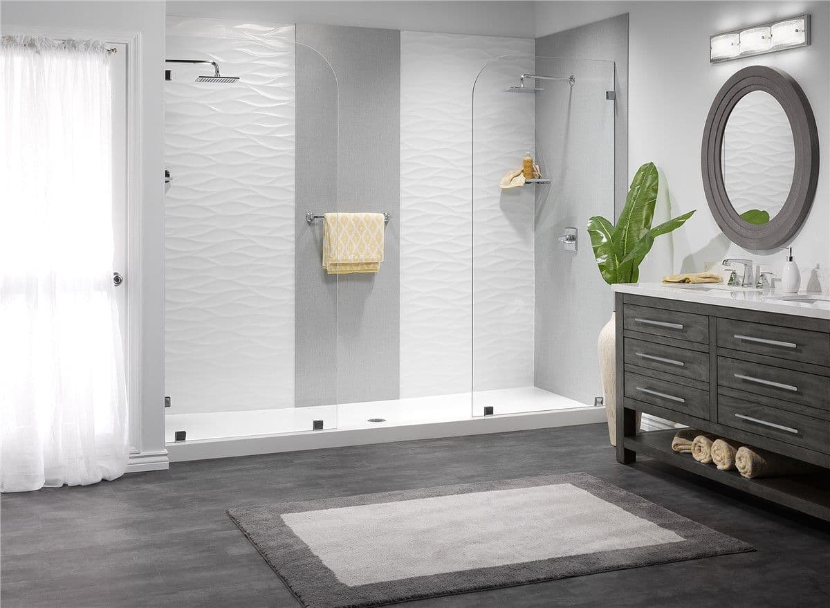 A double walk-in shower with rainfall shower heads, glass partitions, and gray and white textured pattern walls.